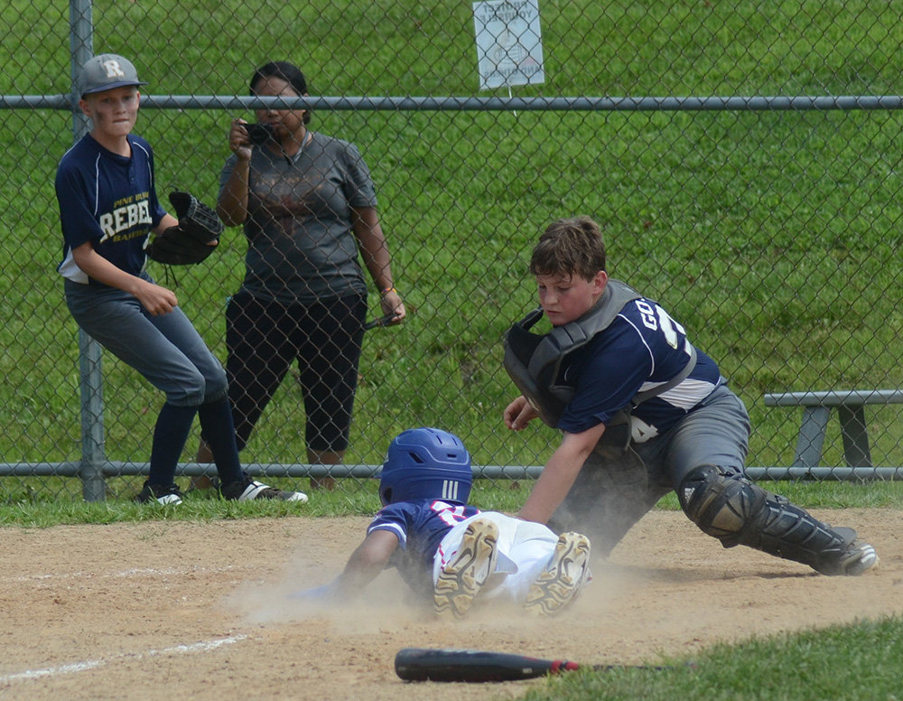 Pine Bush Rebels catcher Ben Gould is late with a tag on a NY Gothams runner.